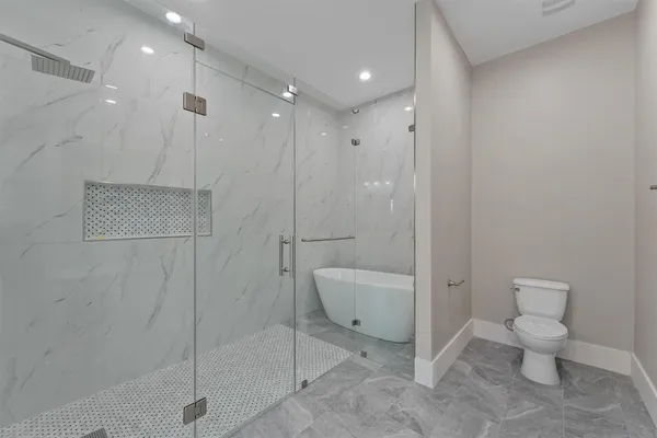 a bathroom with a toilet a sink and shower