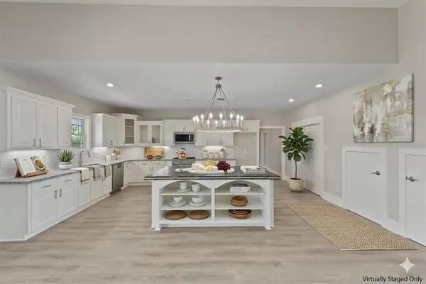 a large white kitchen with a large window