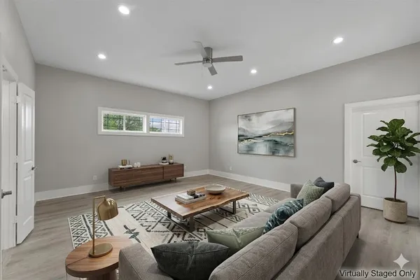 a living room with furniture and a potted plant