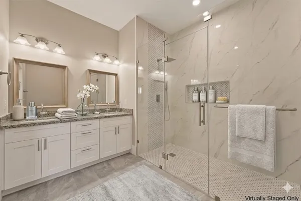 a bathroom with a granite countertop sink mirror and shower