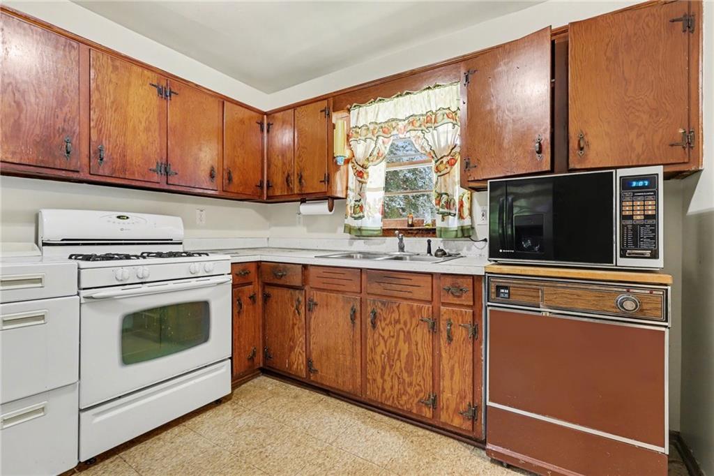 7019 Lake View Lane Doraville, GA 30360 - Photo 12 of 32 a kitchen with stainless steel appliances granite countertop a stove microwave and sink