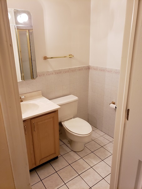 239 North Mill Road, Unit 111 Addison, IL 60101 - Photo 14 of 18 a bathroom with a toilet a sink and a mirror
