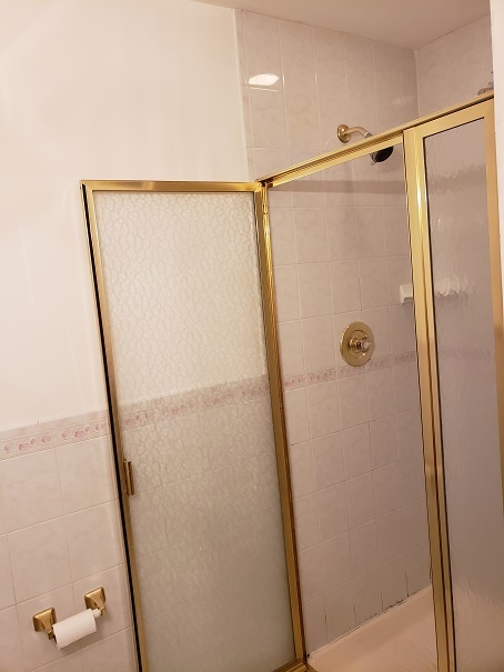 239 North Mill Road, Unit 111 Addison, IL 60101 - Photo 15 of 18 a bathroom with a glass shower door