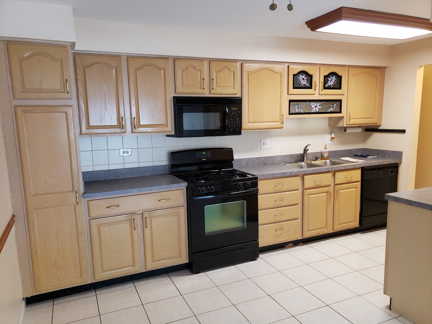 239 North Mill Road, Unit 111 Addison, IL 60101 - Photo 6 of 18 a kitchen with white cabinets a sink and a stove