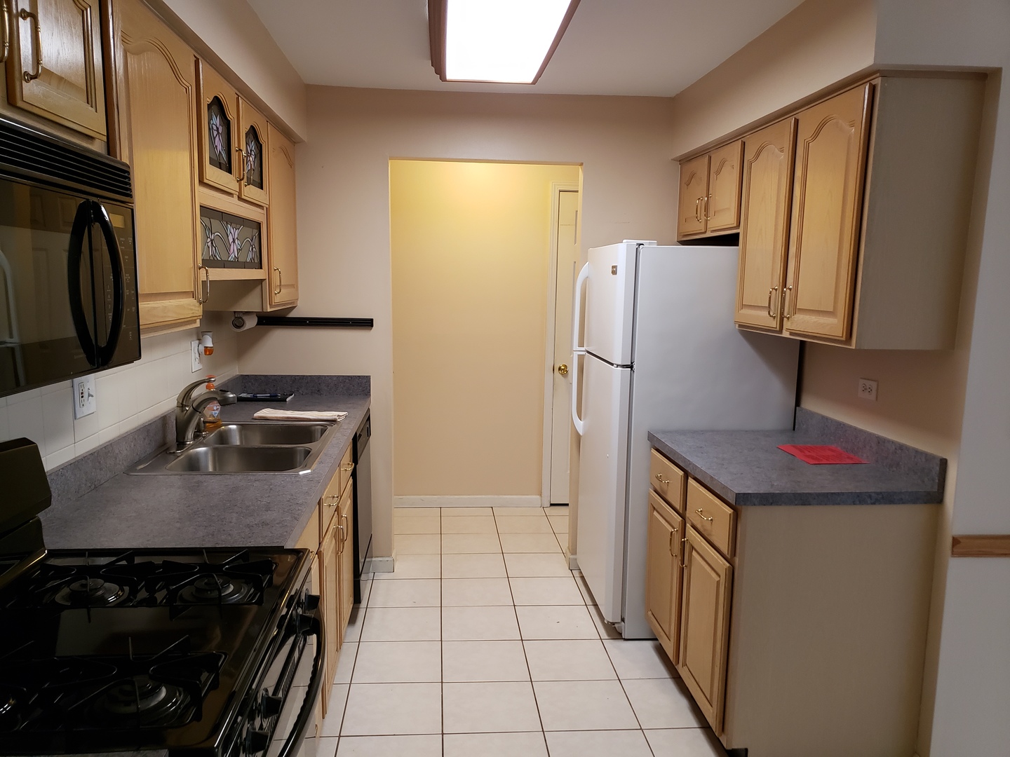239 North Mill Road, Unit 111 Addison, IL 60101 - Photo 7 of 18 a kitchen with a stove and a refrigerator