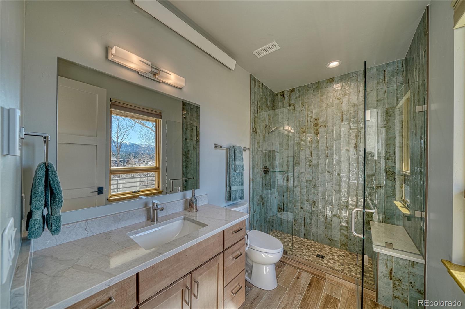 205 Two Rivers Road, Unit G Salida, CO 81201 - Photo 11 of 13 a bathroom with a sink a toilet and shower