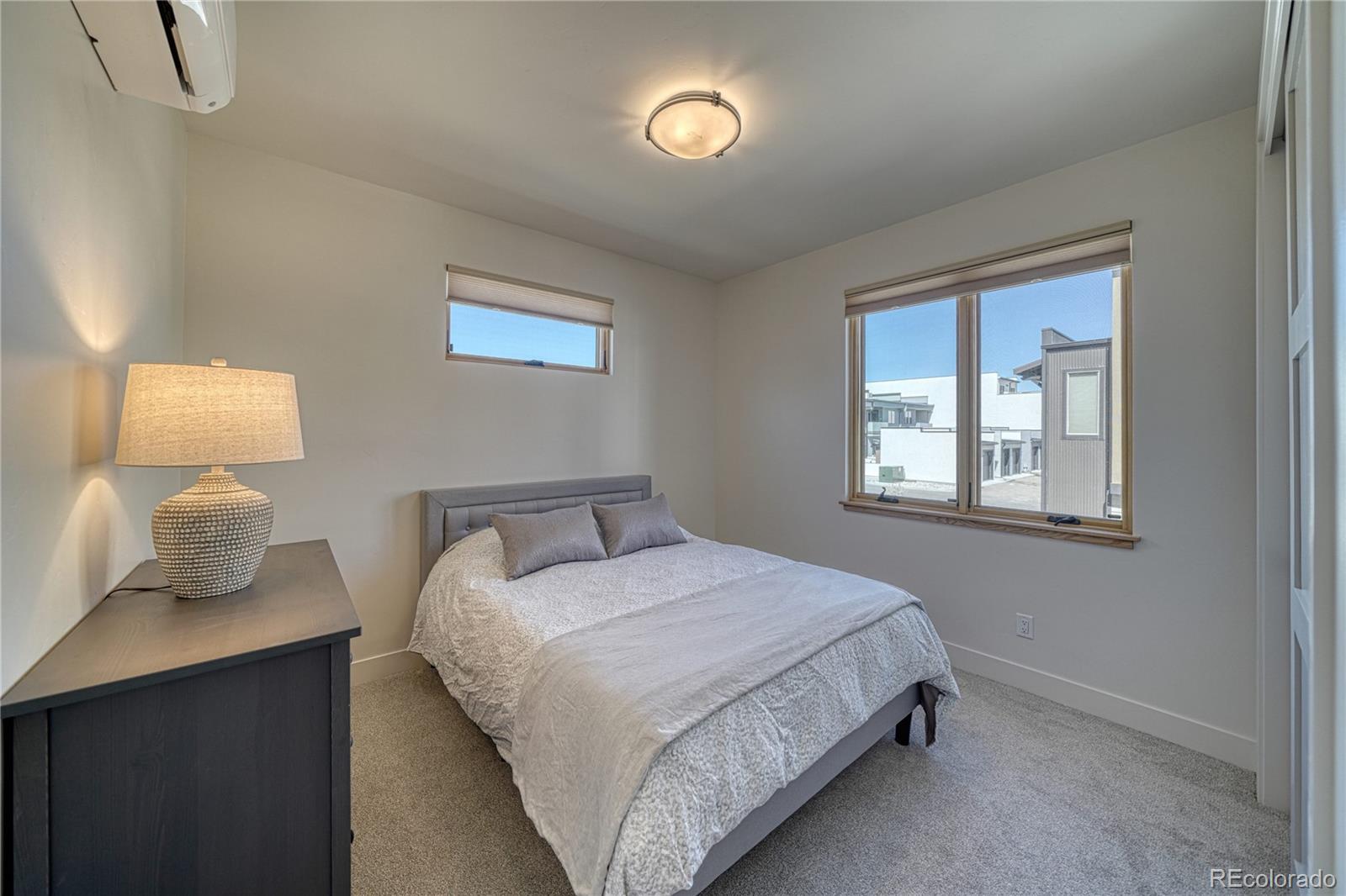 205 Two Rivers Road, Unit G Salida, CO 81201 - Photo 2 of 13 a bedroom with a bed and a lamp on table