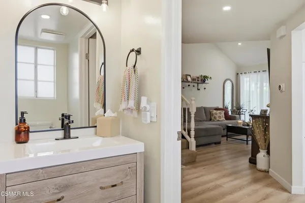 a en suite bathroom with a double vanity and a mirror