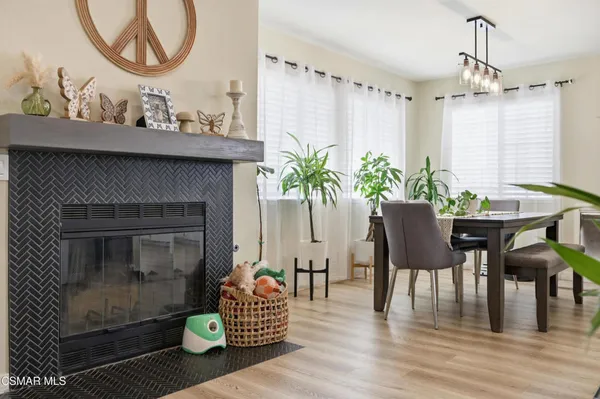 a living room with furniture a chandelier and a fireplace