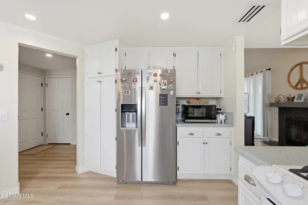 a kitchen with stainless steel appliances a refrigerator sink and cabinets