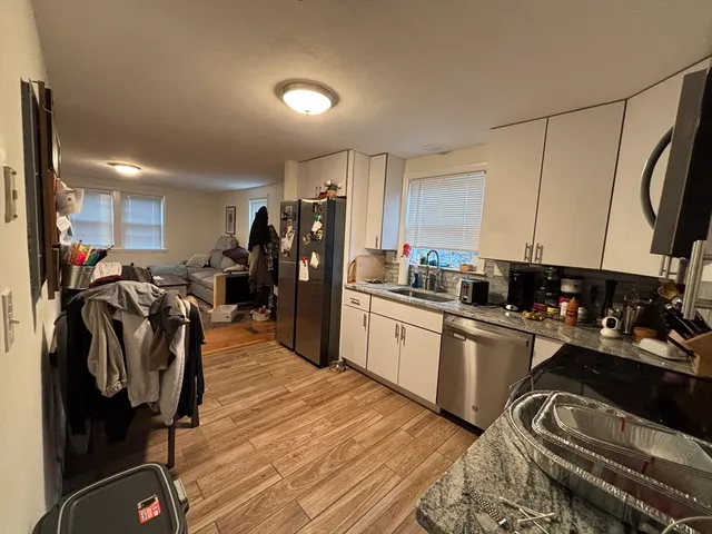 a kitchen with a refrigerator and a sink