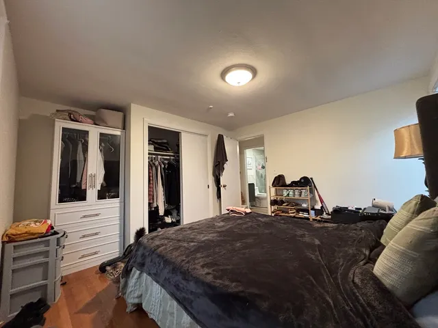 a bed room with a bed and dresser