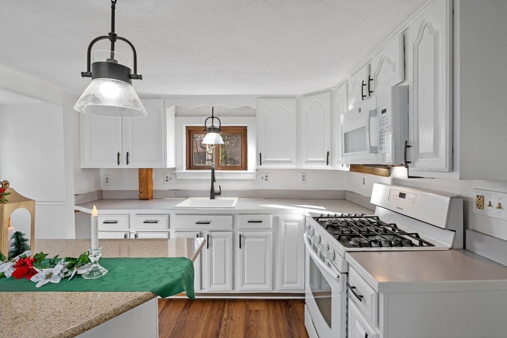 268 Walnut Street Lynn, MA 01905 - Photo 17 of 42 a kitchen with white cabinets and appliances