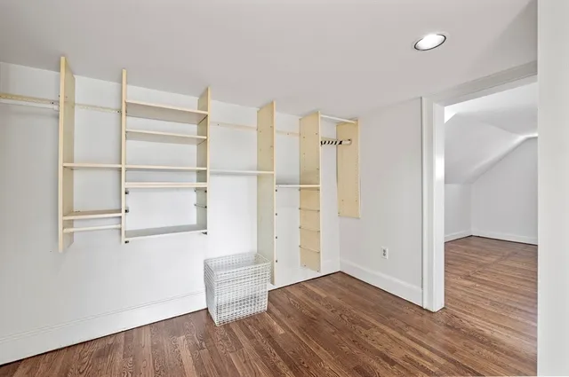 a view of a room with wooden floor