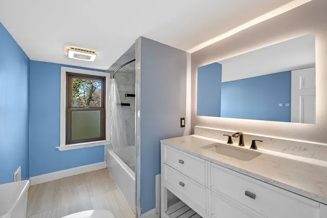 a bathroom with a bath tub with a shower