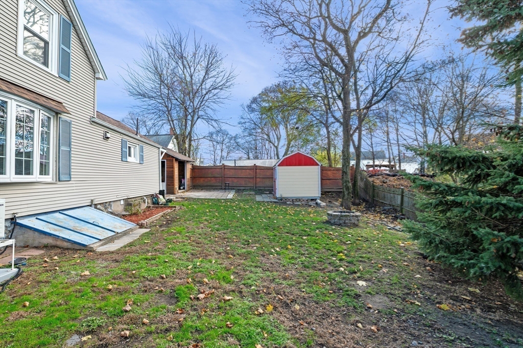 268 Walnut Street Lynn, MA 01905 - Photo 35 of 41 a view of a backyard with table and chairs and wooden fence