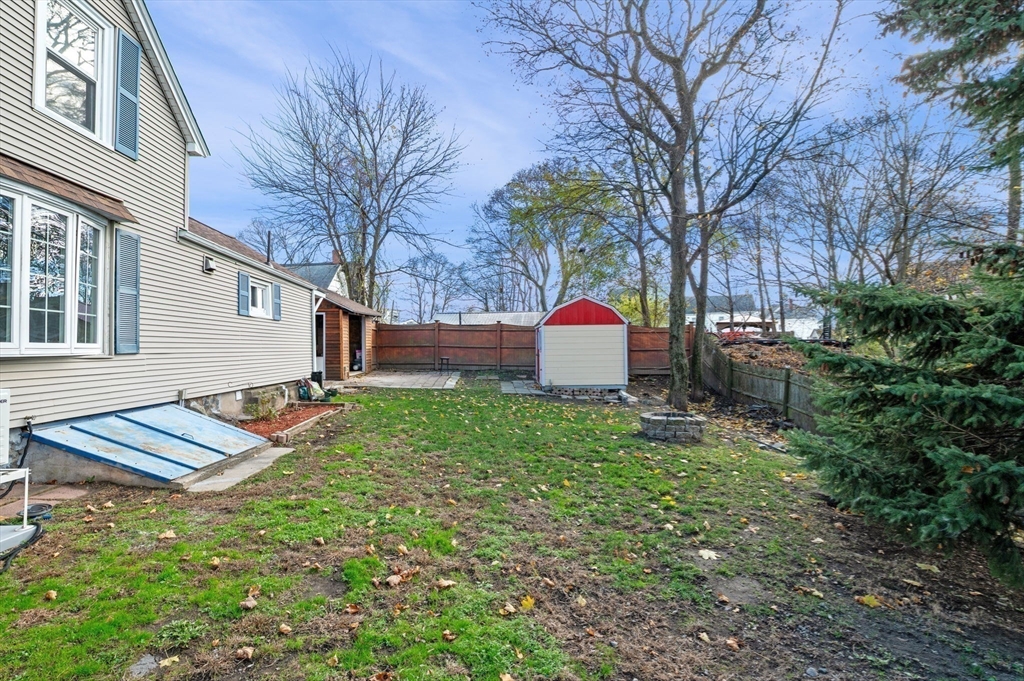 268 Walnut Street Lynn, MA 01905 - Photo 39 of 42 a view of a backyard with table and chairs and wooden fence