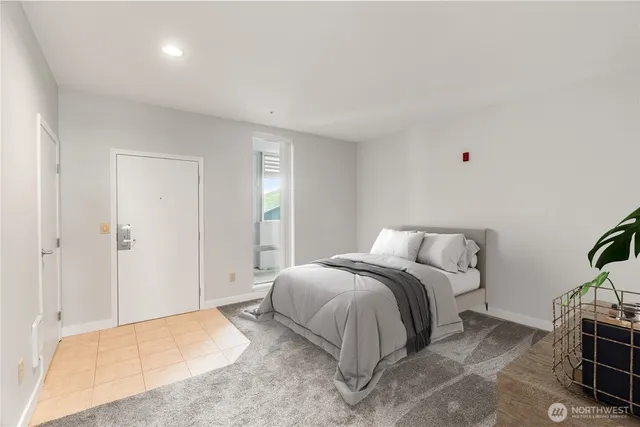 a spacious bedroom with a bed and a view of bathroom