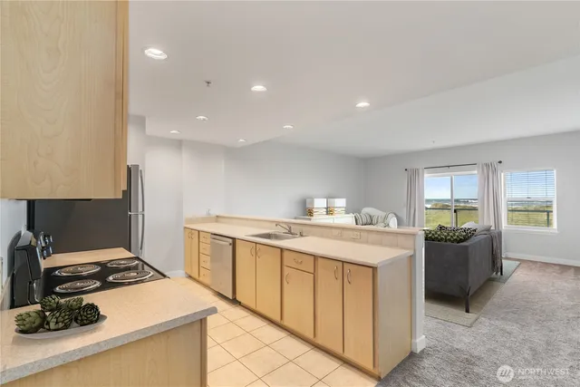 a kitchen with a stove and a refrigerator
