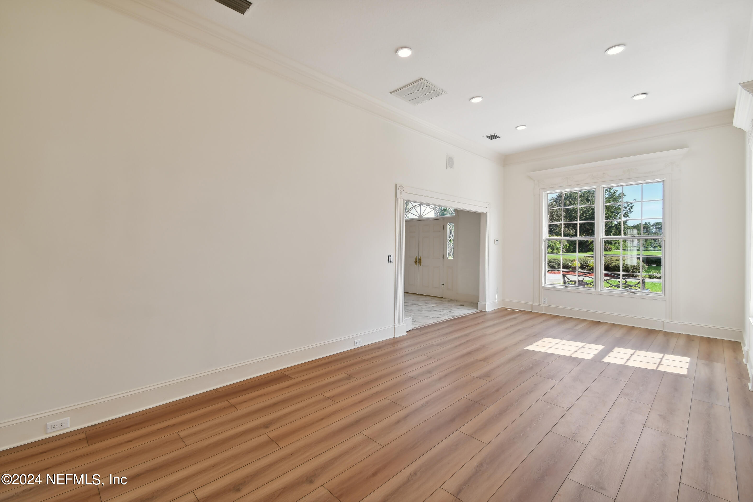 13936 Mandarin Road Jacksonville, FL 32223 - Photo 20 of 86 an empty room with wooden floor and windows