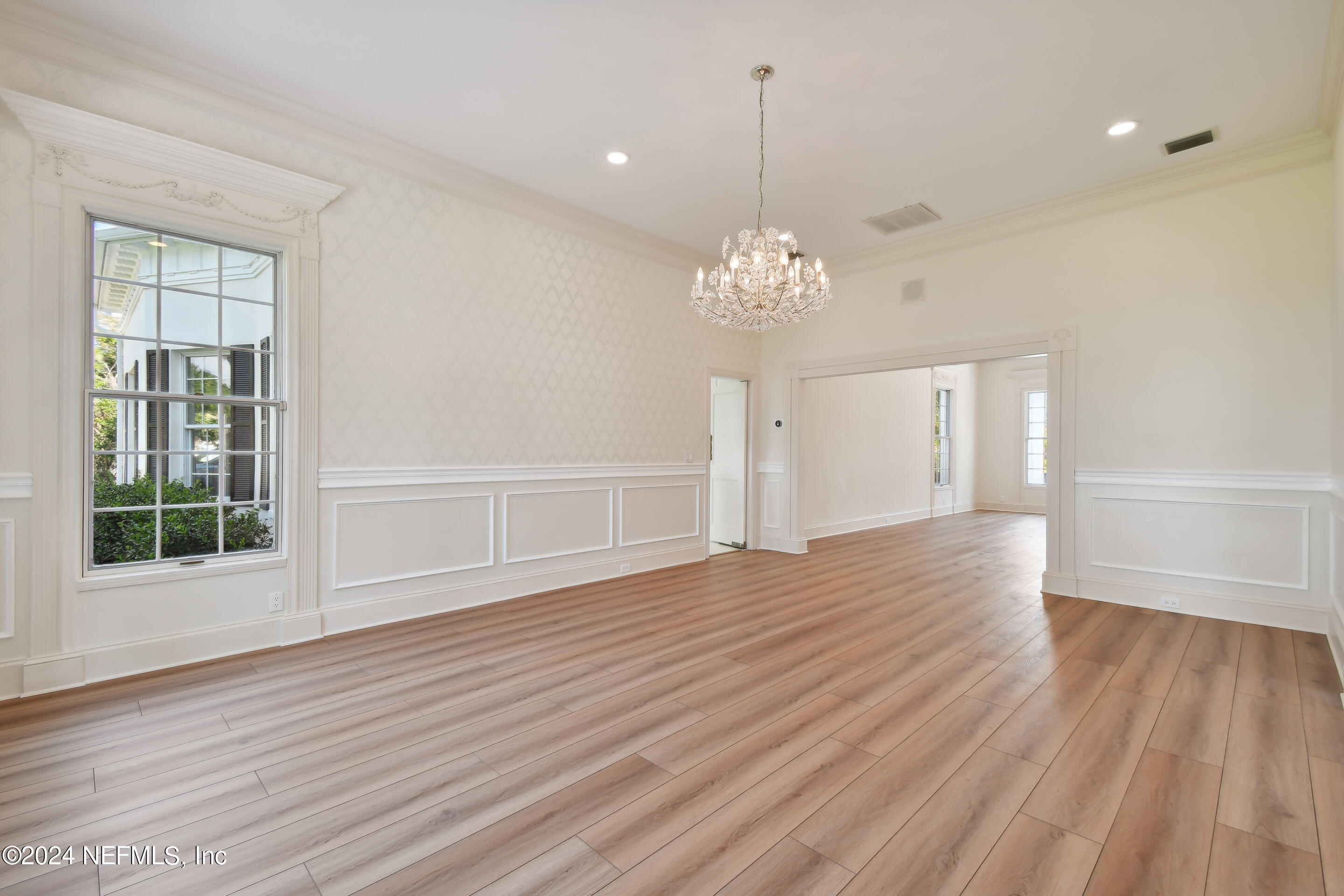 13936 Mandarin Road Jacksonville, FL 32223 - Photo 24 of 86 a view of an empty room with wooden floor and a window