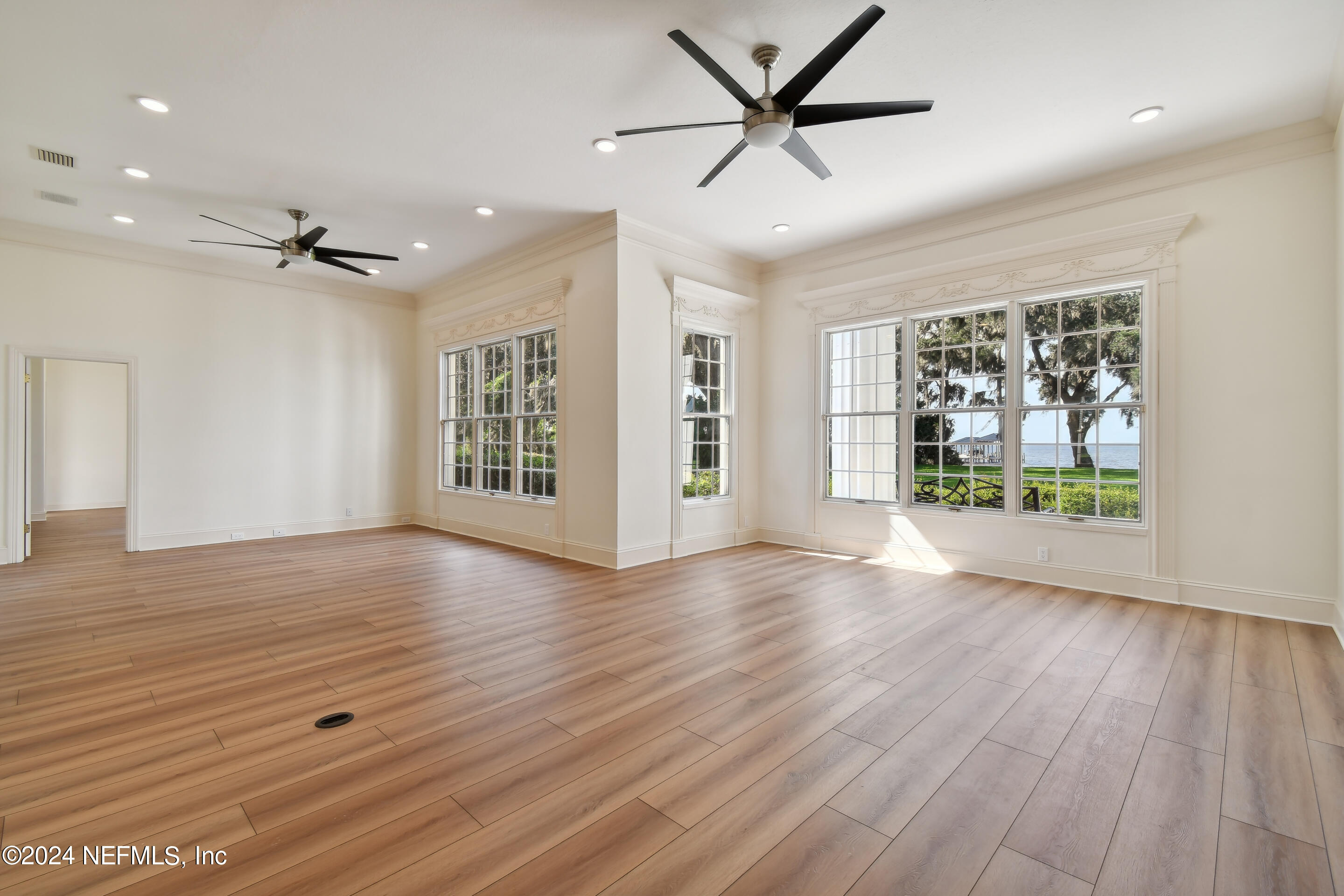 13936 Mandarin Road Jacksonville, FL 32223 - Photo 26 of 86 wooden floor in an empty room with a window