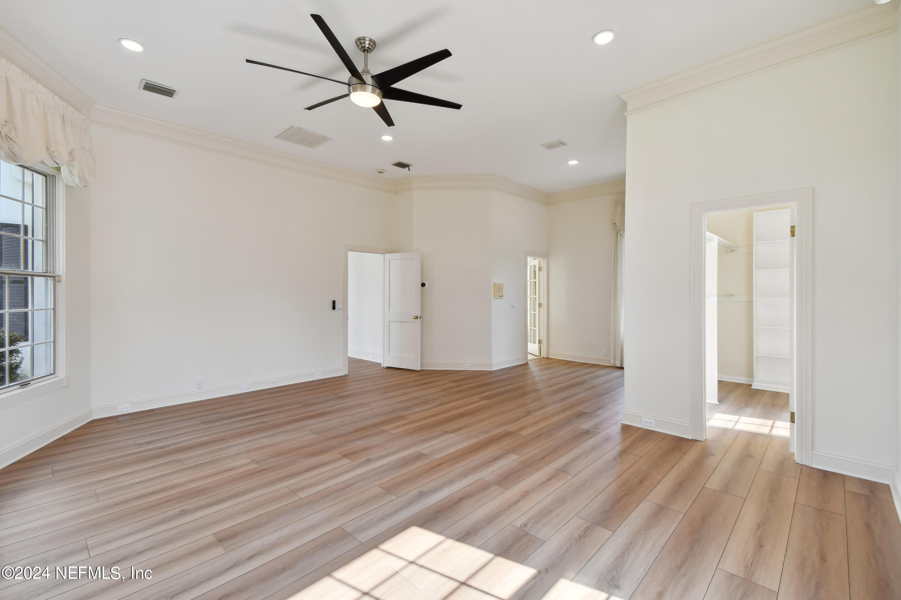 13936 Mandarin Road Jacksonville, FL 32223 - Photo 31 of 86 a view of an empty room with wooden floor and a window