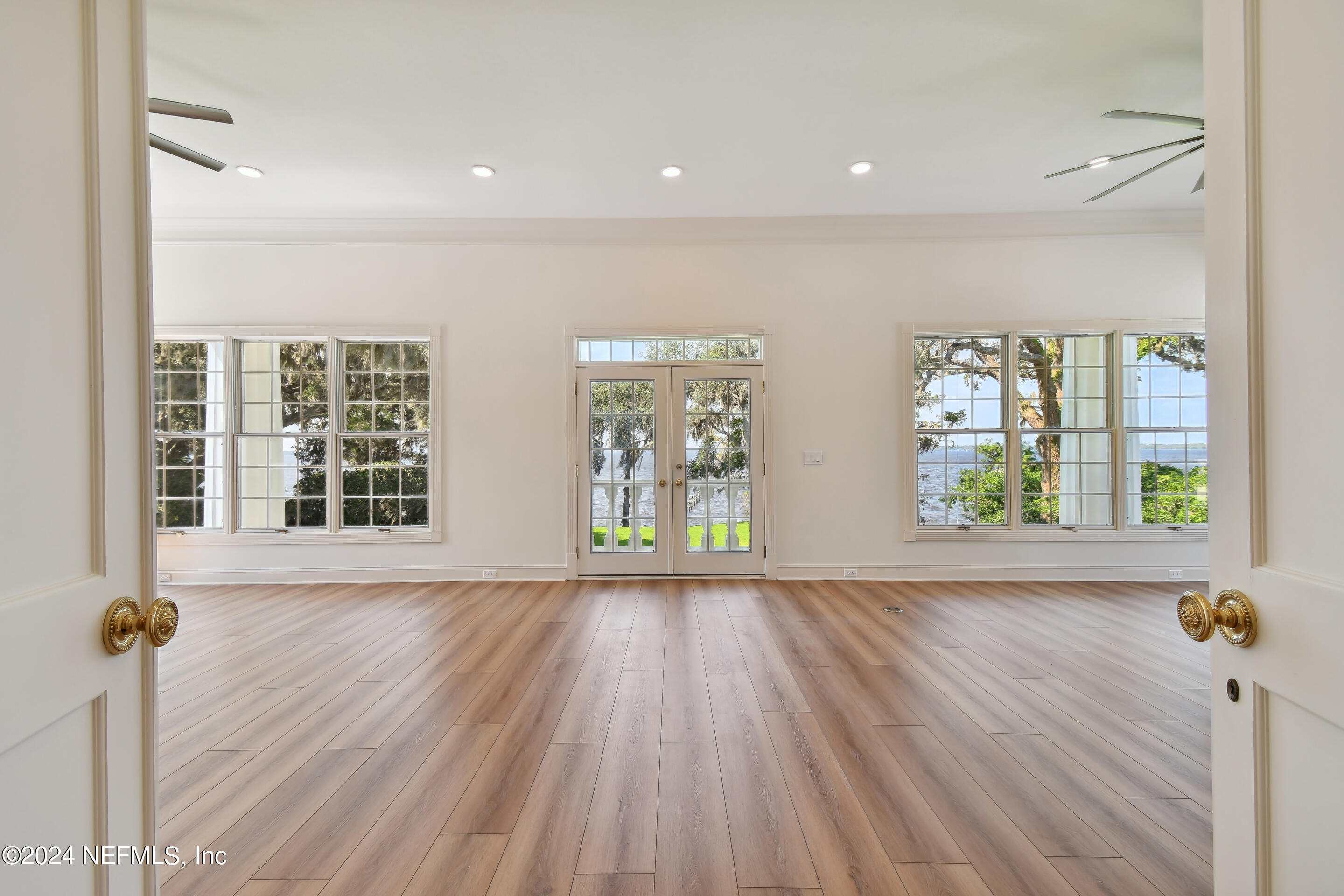 13936 Mandarin Road Jacksonville, FL 32223 - Photo 38 of 86 a view of an empty room with wooden floor and a window