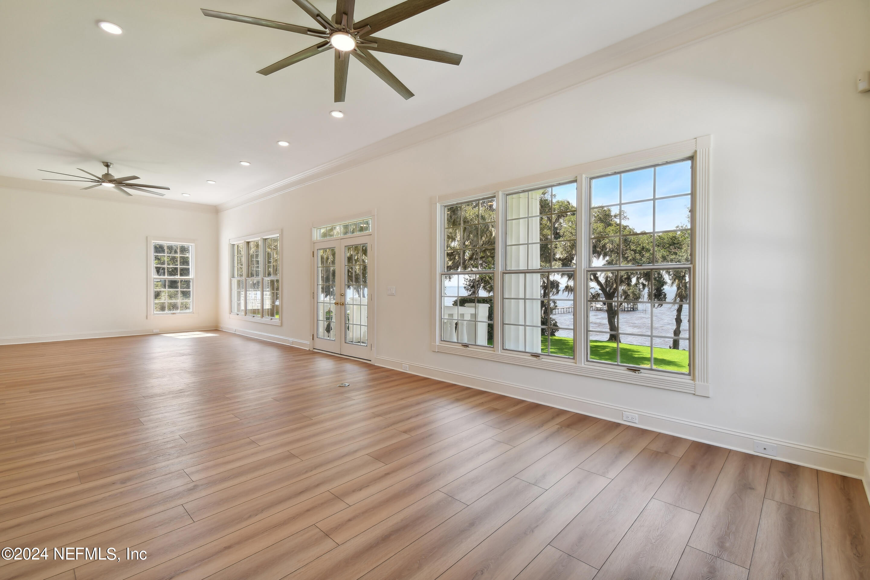 13936 Mandarin Road Jacksonville, FL 32223 - Photo 39 of 86 a view of an empty room with a window and wooden floor
