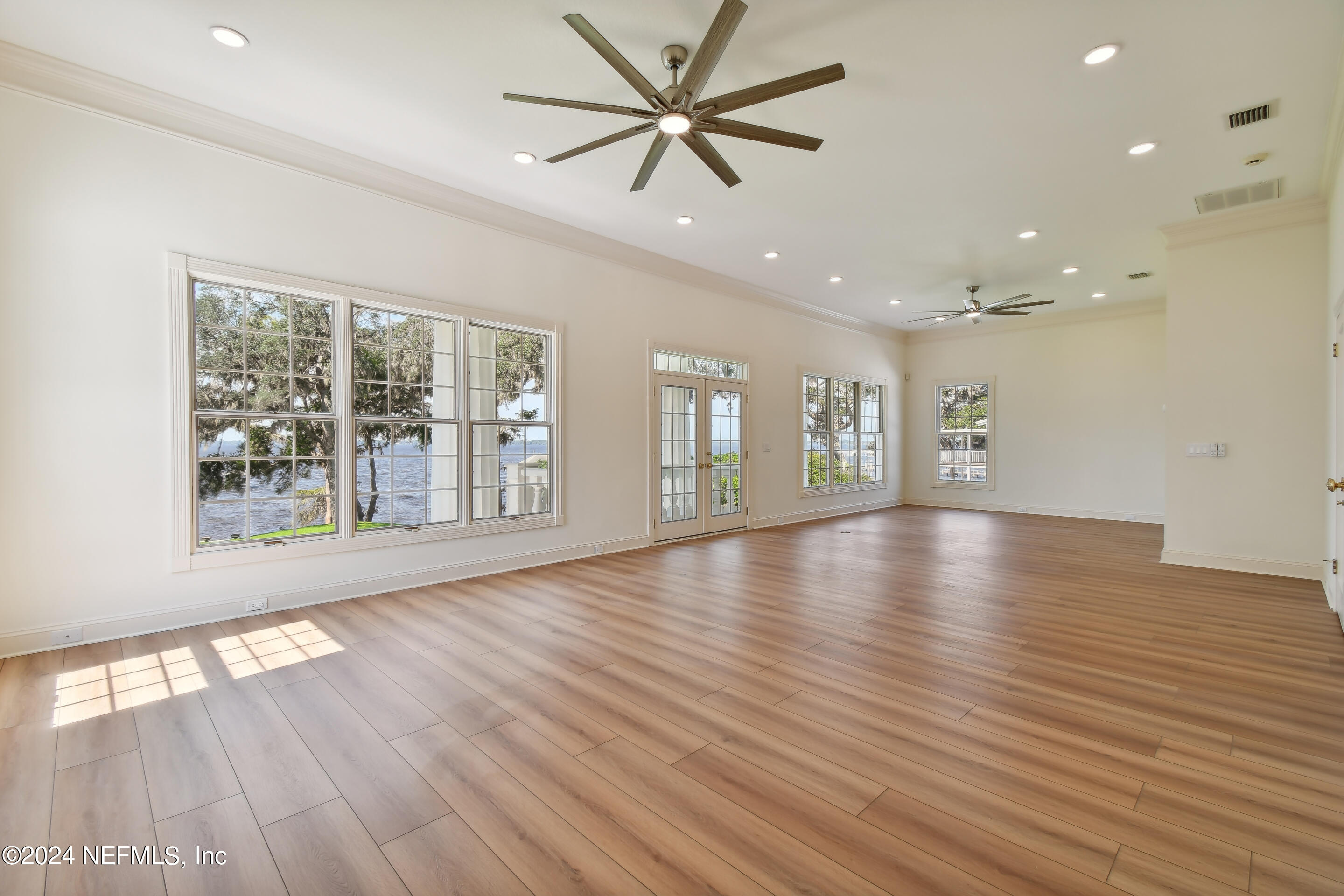 13936 Mandarin Road Jacksonville, FL 32223 - Photo 40 of 86 wooden floor in an empty room with a window