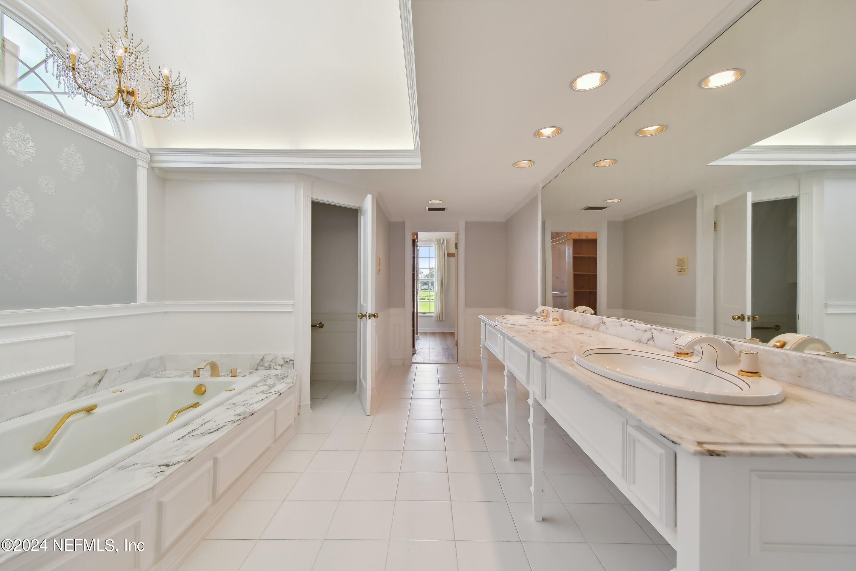 13936 Mandarin Road Jacksonville, FL 32223 - Photo 43 of 86 a spacious bathroom with a granite countertop sink a mirror and a bathtub