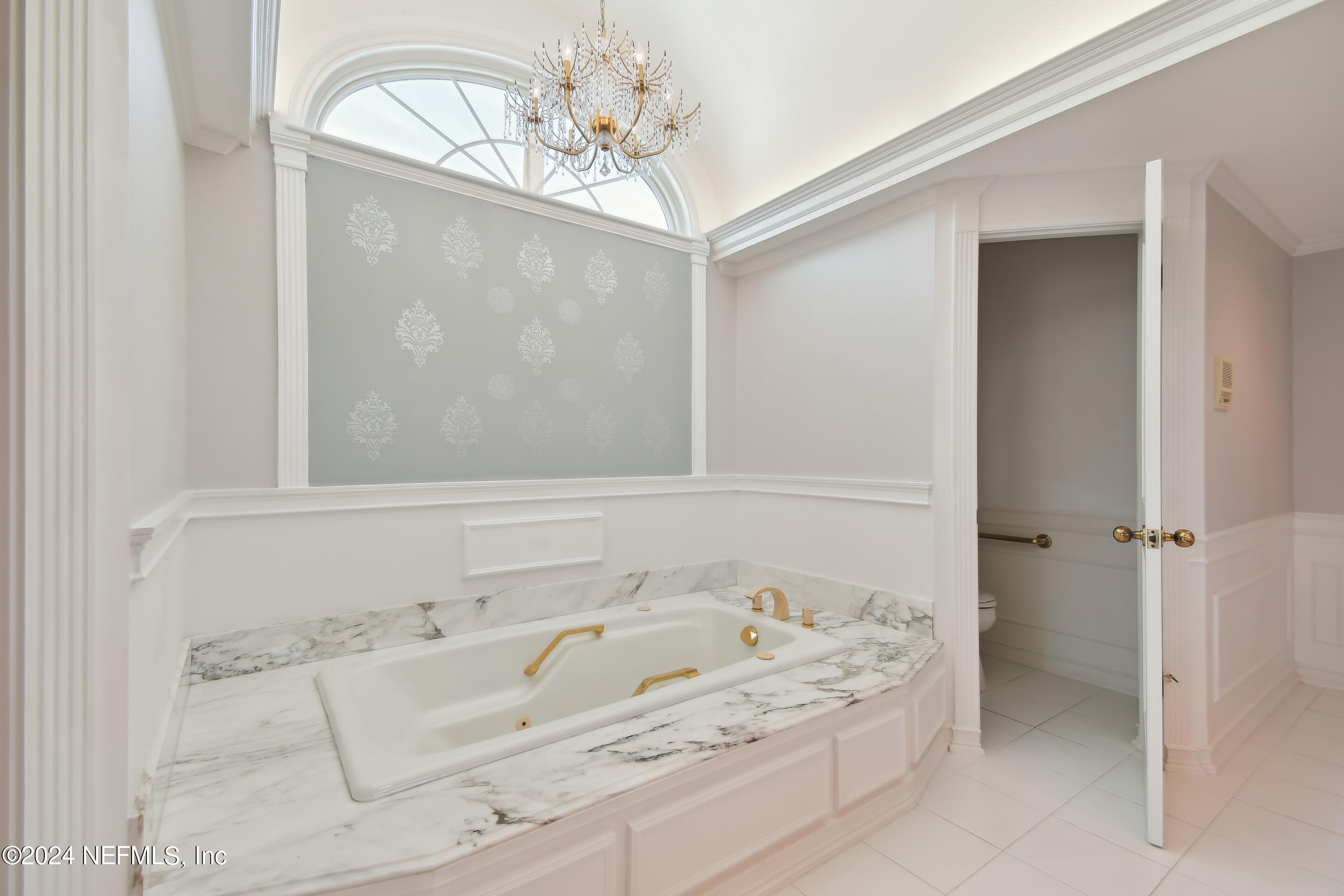13936 Mandarin Road Jacksonville, FL 32223 - Photo 45 of 86 a bathroom with a tub sink and chandelier