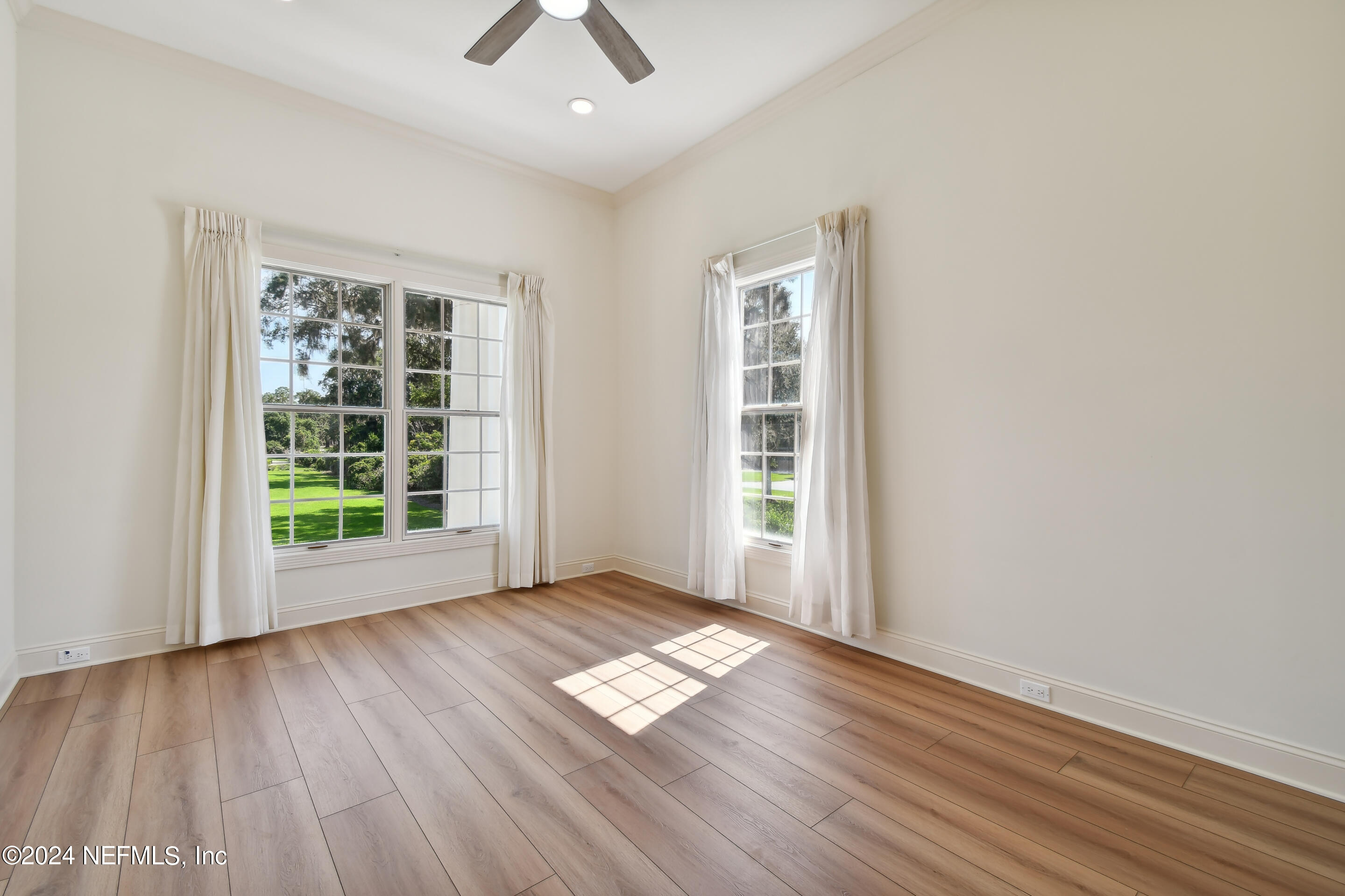 13936 Mandarin Road Jacksonville, FL 32223 - Photo 49 of 86 an empty room with wooden floor and windows