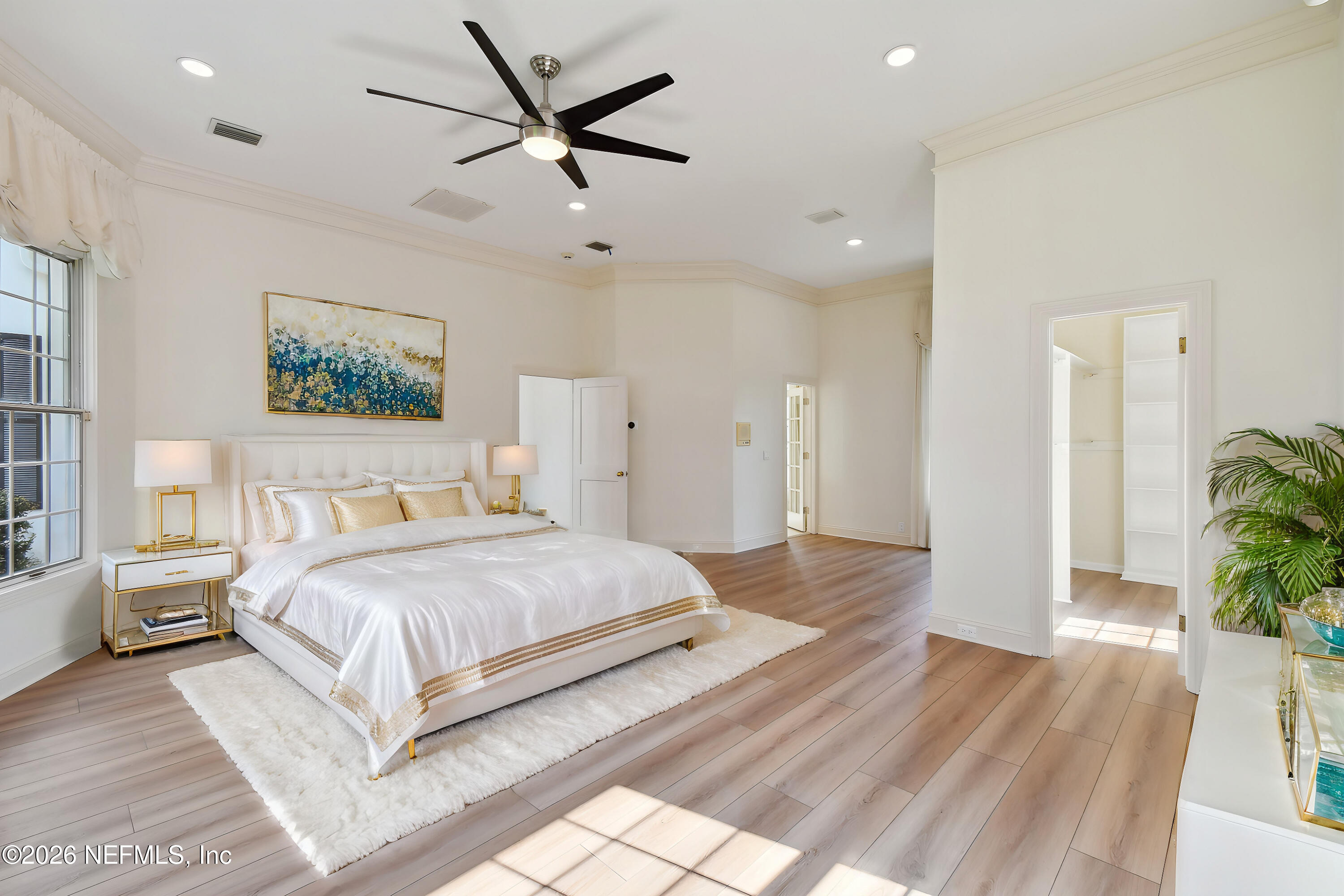 13936 Mandarin Road Jacksonville, FL 32223 - Photo 9 of 86 a spacious bedroom with a large bed and a chandelier