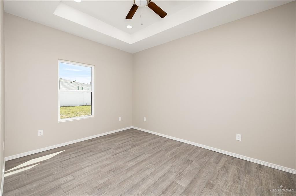 2747 Naples Street Weslaco, TX 78596 - Photo 11 of 13 wooden floor in an empty room with a window