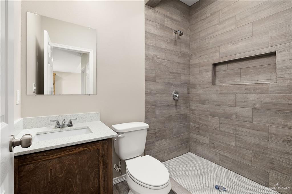2747 Naples Street Weslaco, TX 78596 - Photo 12 of 13 a bathroom with a sink a toilet and shower
