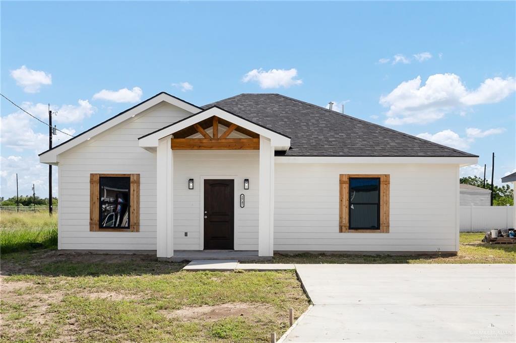 2747 Naples Street Weslaco, TX 78596 - Photo 2 of 13 a front view of a house with a yard
