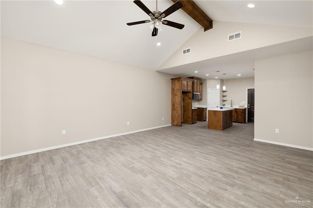 2747 Naples Street Weslaco, TX 78596 - Photo 4 of 13 an empty room with kitchen and ceiling fan ceiling fan