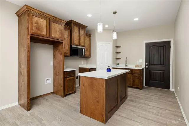 a kitchen with stainless steel appliances granite countertop a refrigerator a sink a stove and oven