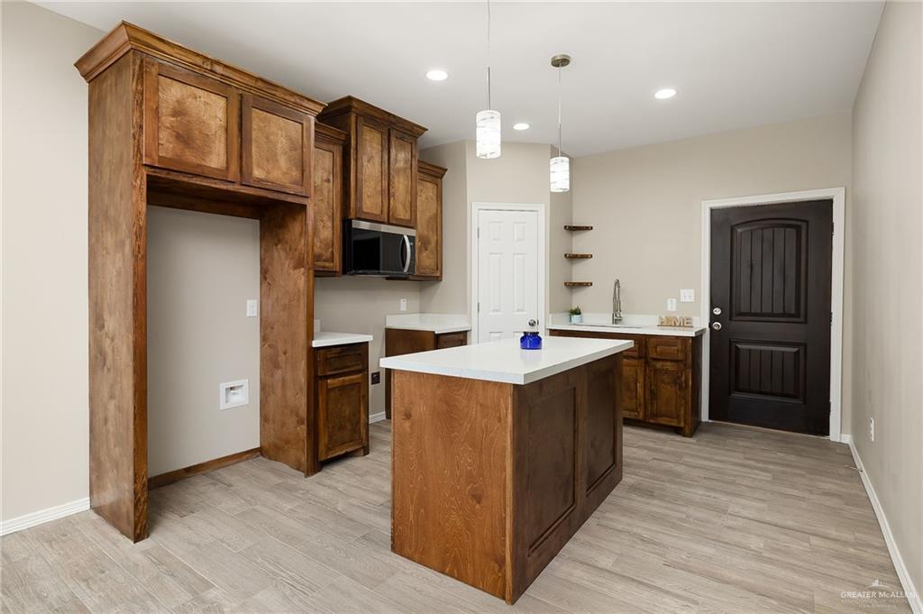 2747 Naples Street Weslaco, TX 78596 - Photo 5 of 13 a kitchen with stainless steel appliances granite countertop a refrigerator a sink a stove and oven