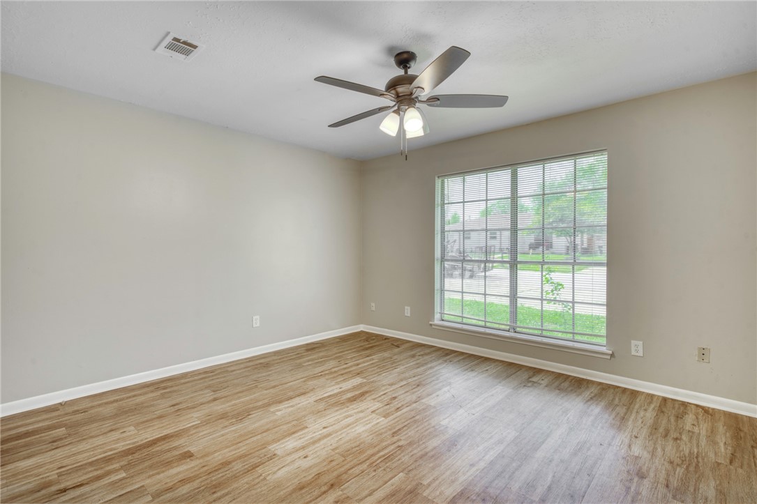 3911 Olive Street, Unit B Bryan, TX 77801 - Photo 11 of 12 a view of an empty room with wooden floor and a window