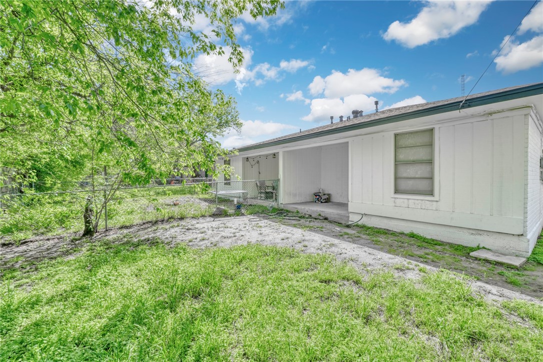 3911 Olive Street, Unit B Bryan, TX 77801 - Photo 12 of 12 a backyard of a house with table and chairs
