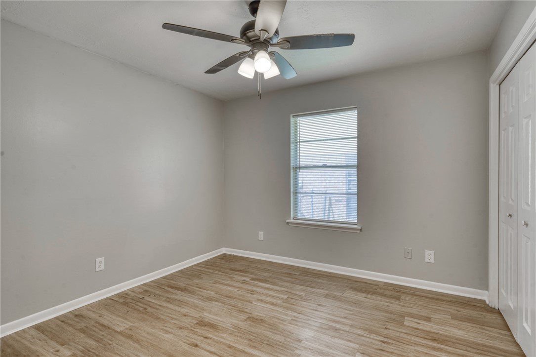 3911 Olive Street, Unit B Bryan, TX 77801 - Photo 9 of 12 an empty room with a window and a fan