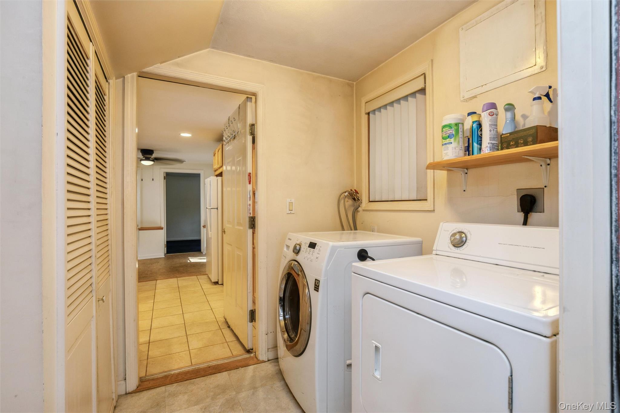 115 Clarendon Road Ronkonkoma, NY 11779 - Photo 23 of 45 Dedicated laundry area featuring a louvered bi-fold closet and a window with blinds. Utilities