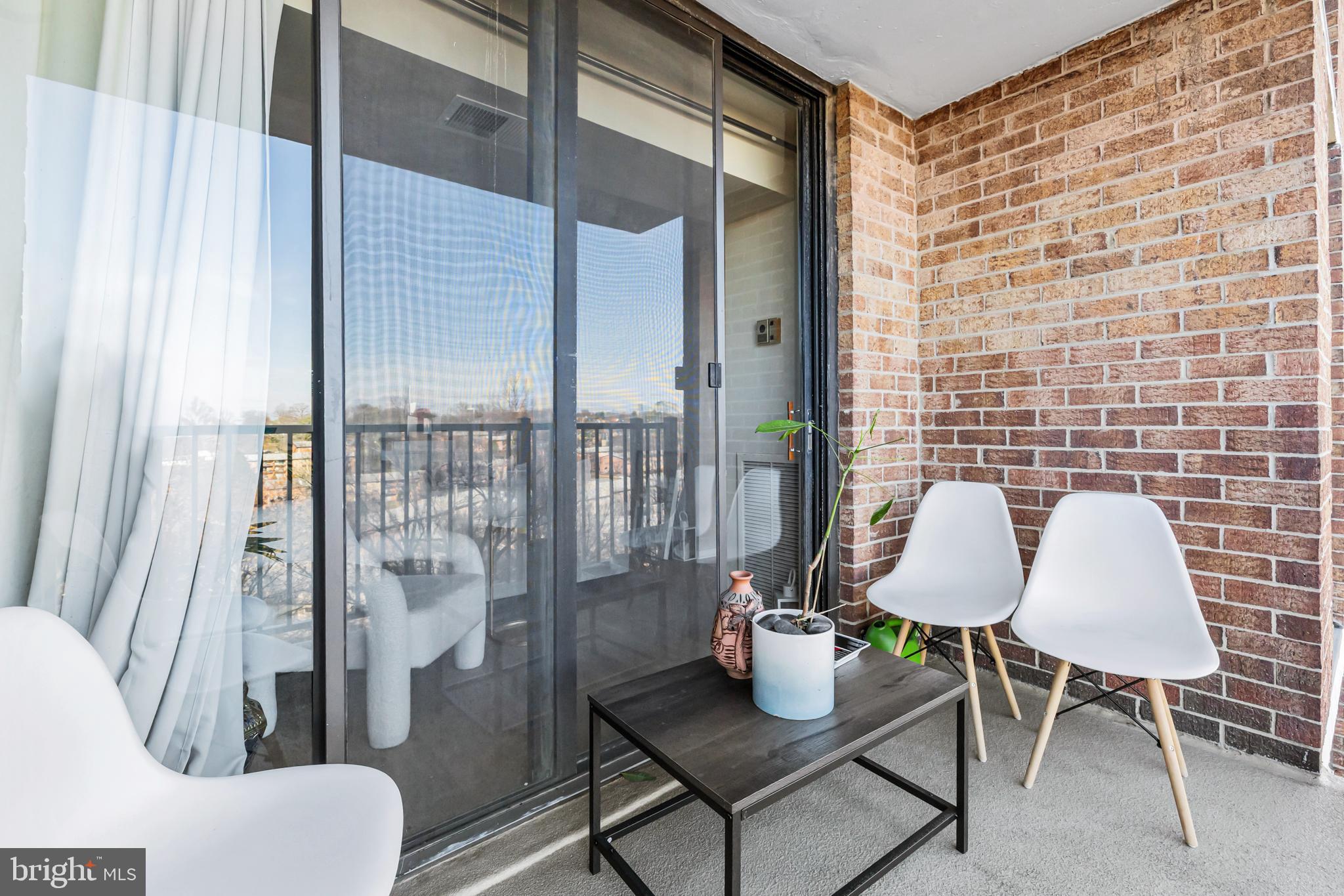 2300 Pimmit Drive, Unit 807 Falls Church, VA 22043 - Photo 12 of 33 a living room with furniture and a potted plant