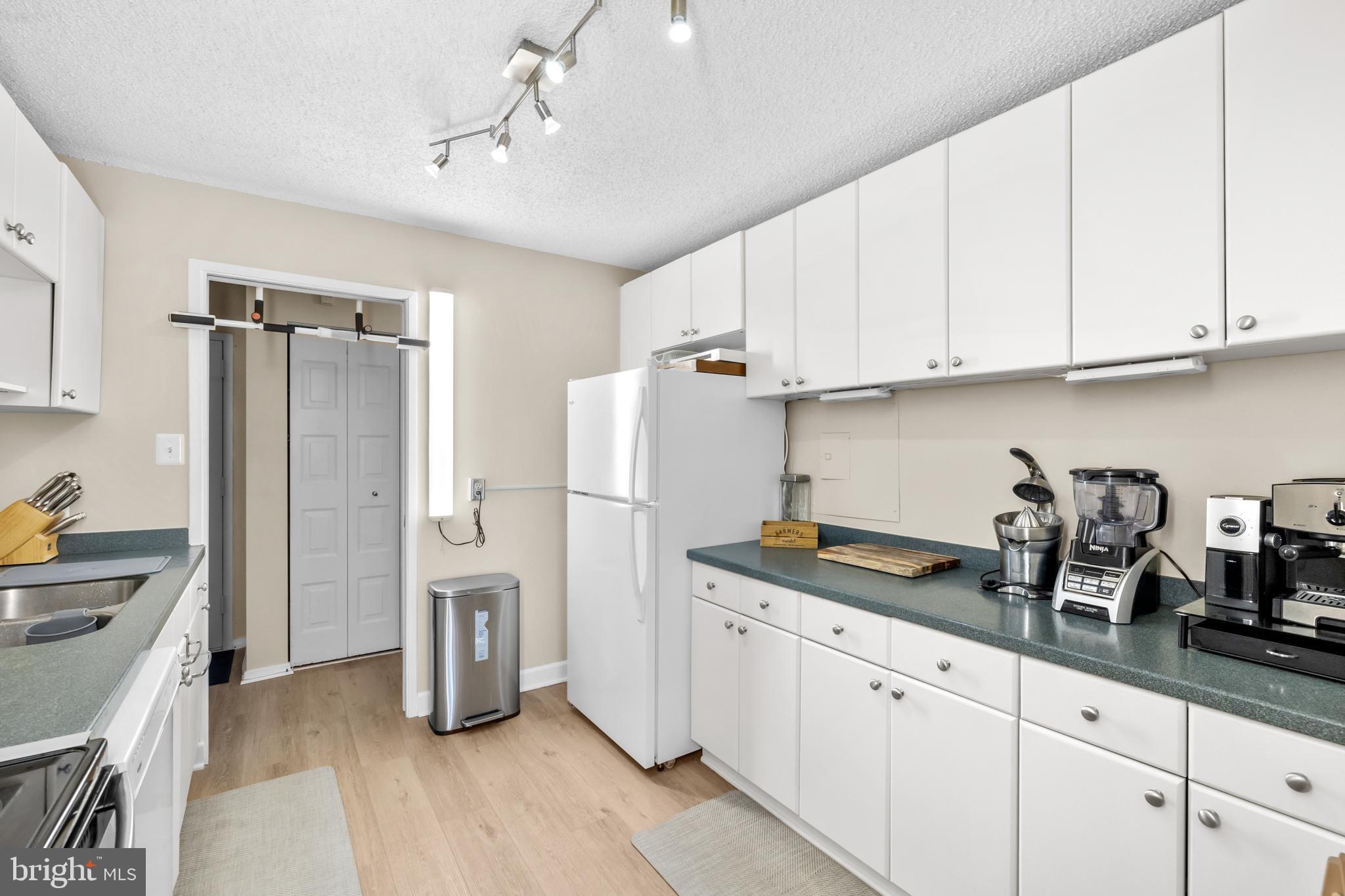 2300 Pimmit Drive, Unit 807 Falls Church, VA 22043 - Photo 15 of 33 a kitchen with refrigerator and cabinets