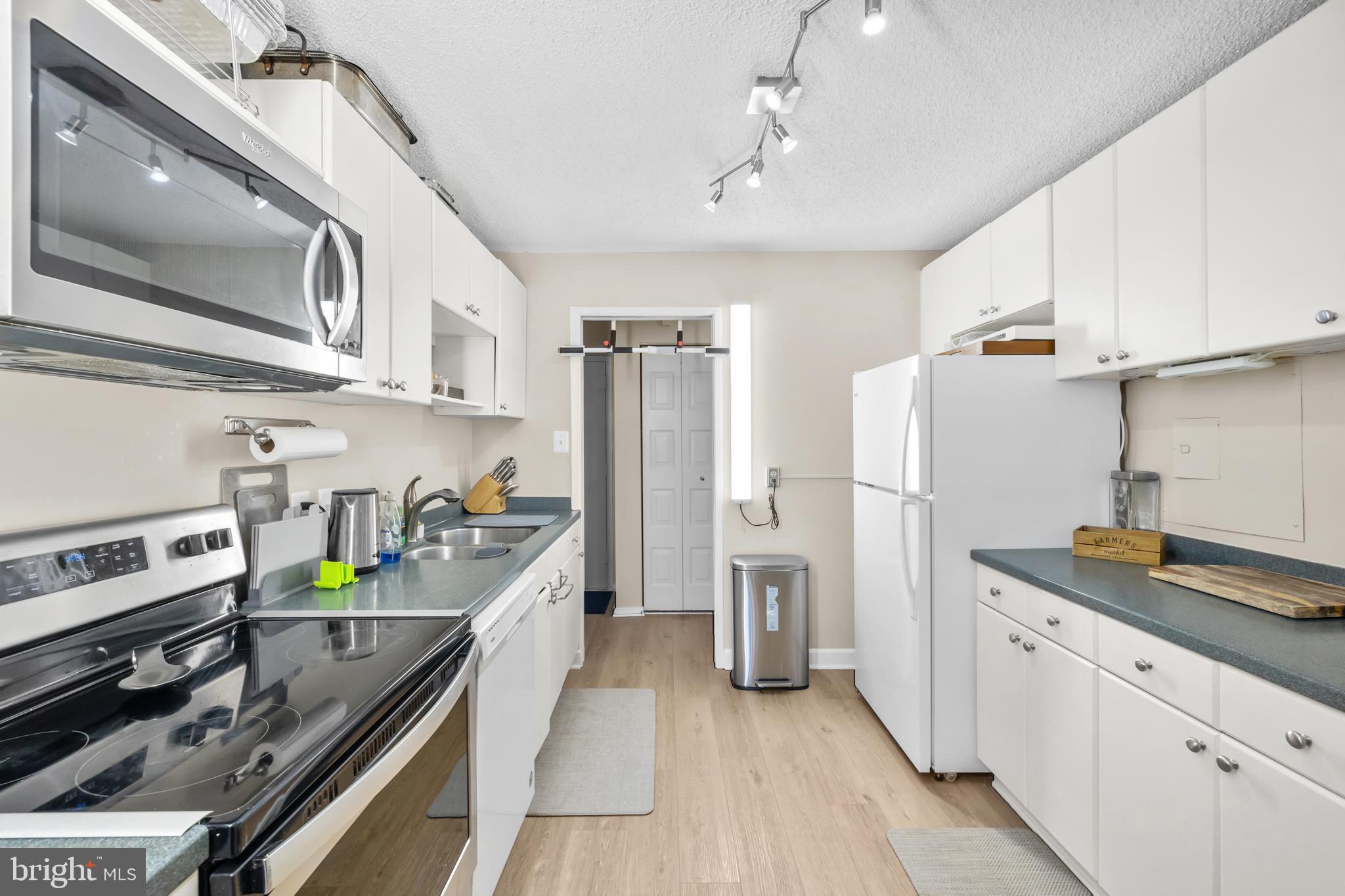 2300 Pimmit Drive, Unit 807 Falls Church, VA 22043 - Photo 17 of 33 a kitchen that has a cabinets and a stove