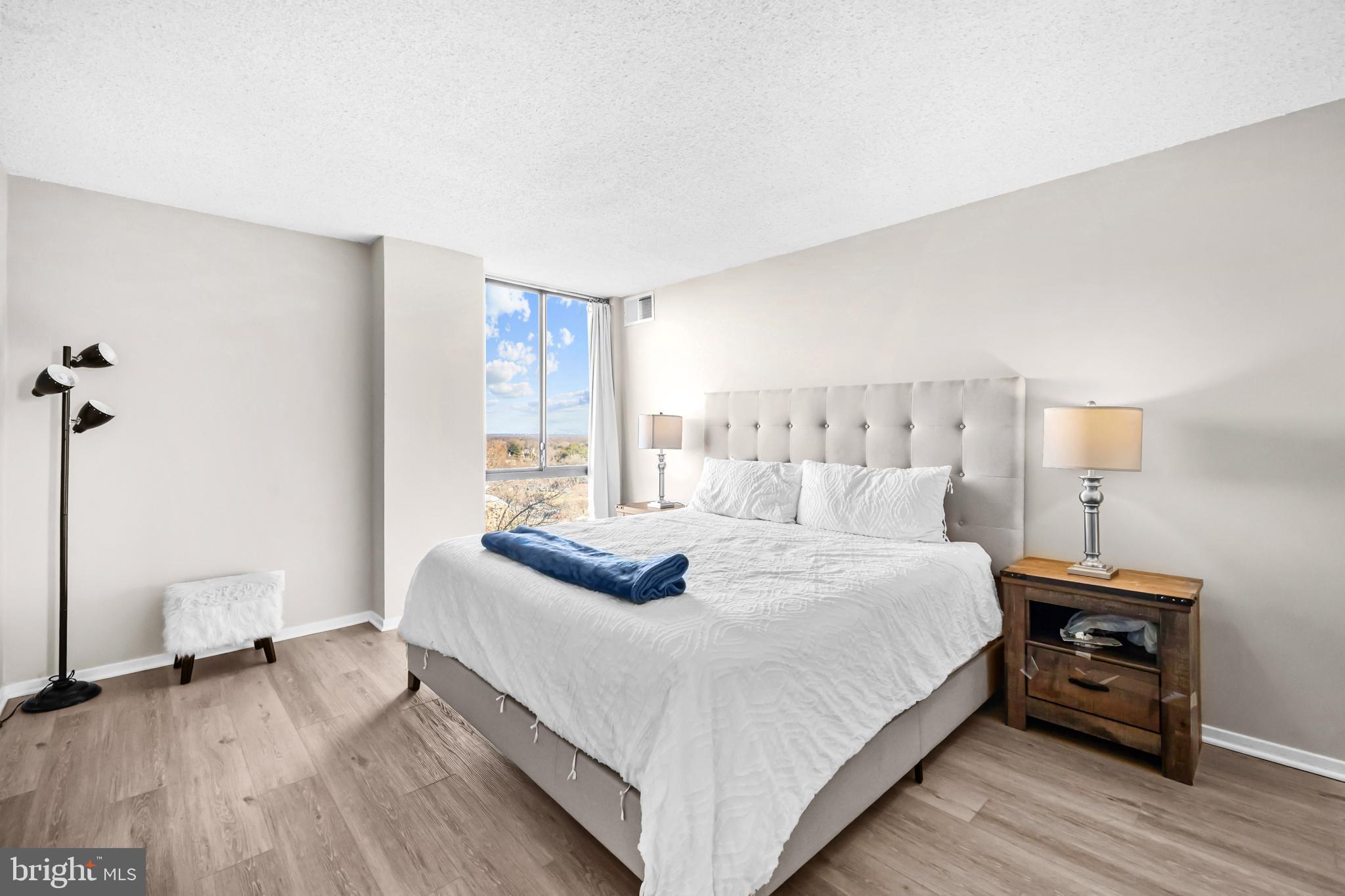 2300 Pimmit Drive, Unit 807 Falls Church, VA 22043 - Photo 18 of 33 a bedroom with a bed and a table