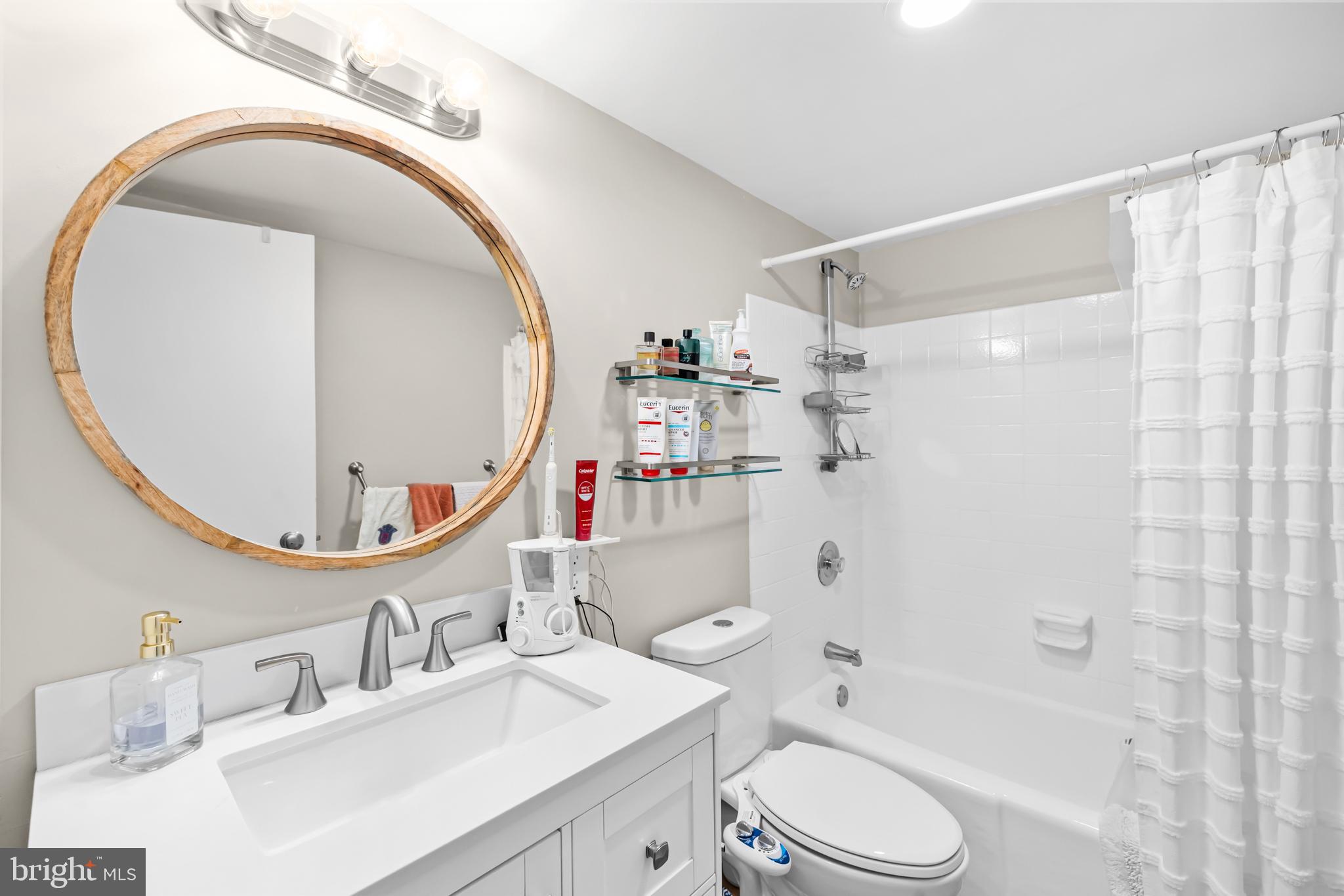 2300 Pimmit Drive, Unit 807 Falls Church, VA 22043 - Photo 21 of 33 a bathroom with a sink a toilet and shower