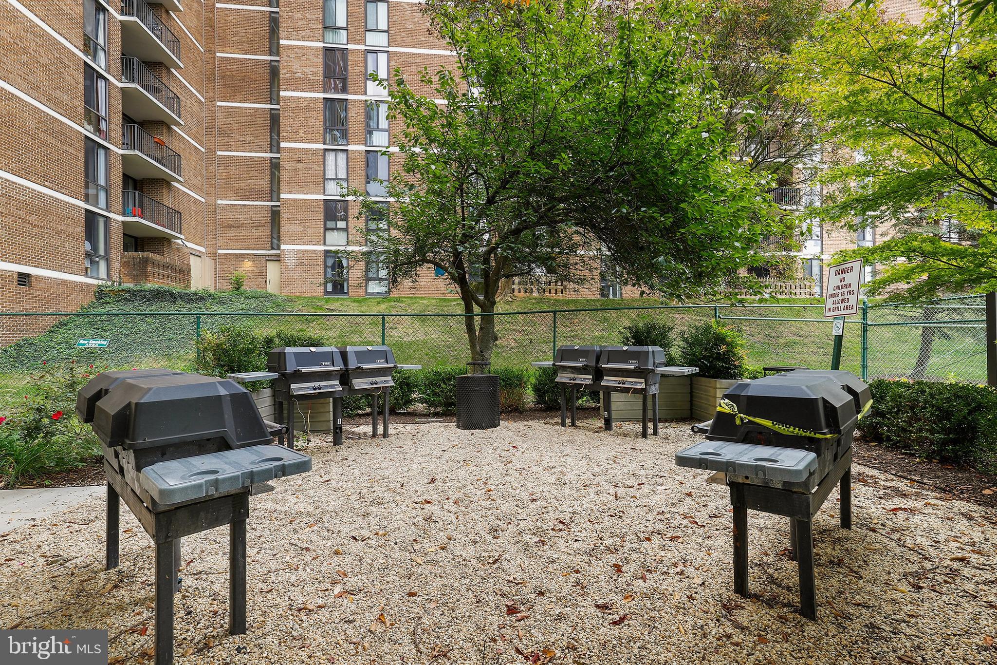 2300 Pimmit Drive, Unit 807 Falls Church, VA 22043 - Photo 29 of 33 a view of a chairs and table in a backyard